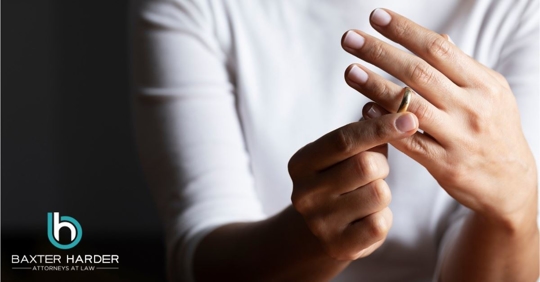 woman taking wedding ring off finger