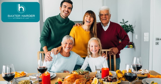 family smiling for camera at a Thanksgiving dinner table